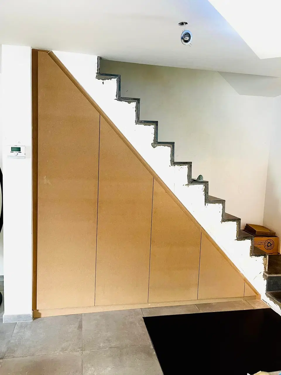 Un placard toute hauteur sous un escalier beton — pendant les travaux